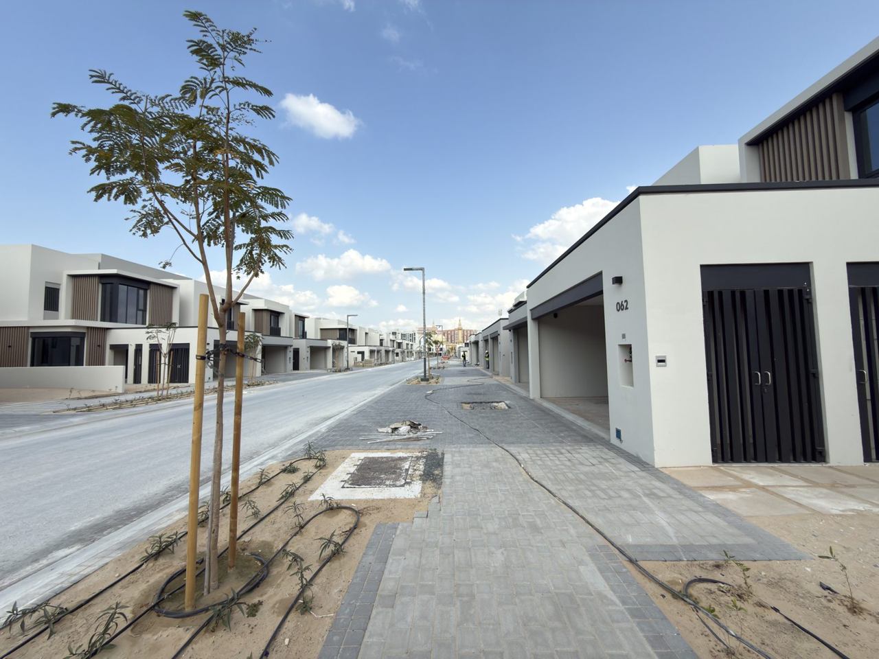 Jebel Ali Village townhouses · Representative site photo, April 2026