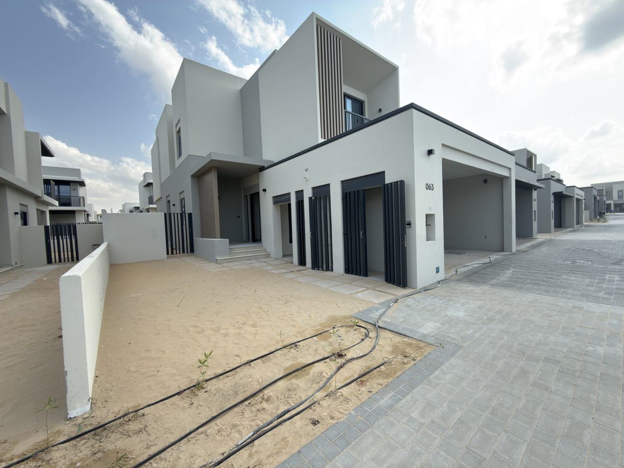 Jebel Ali Village townhouses · Representative site photo, April 2026